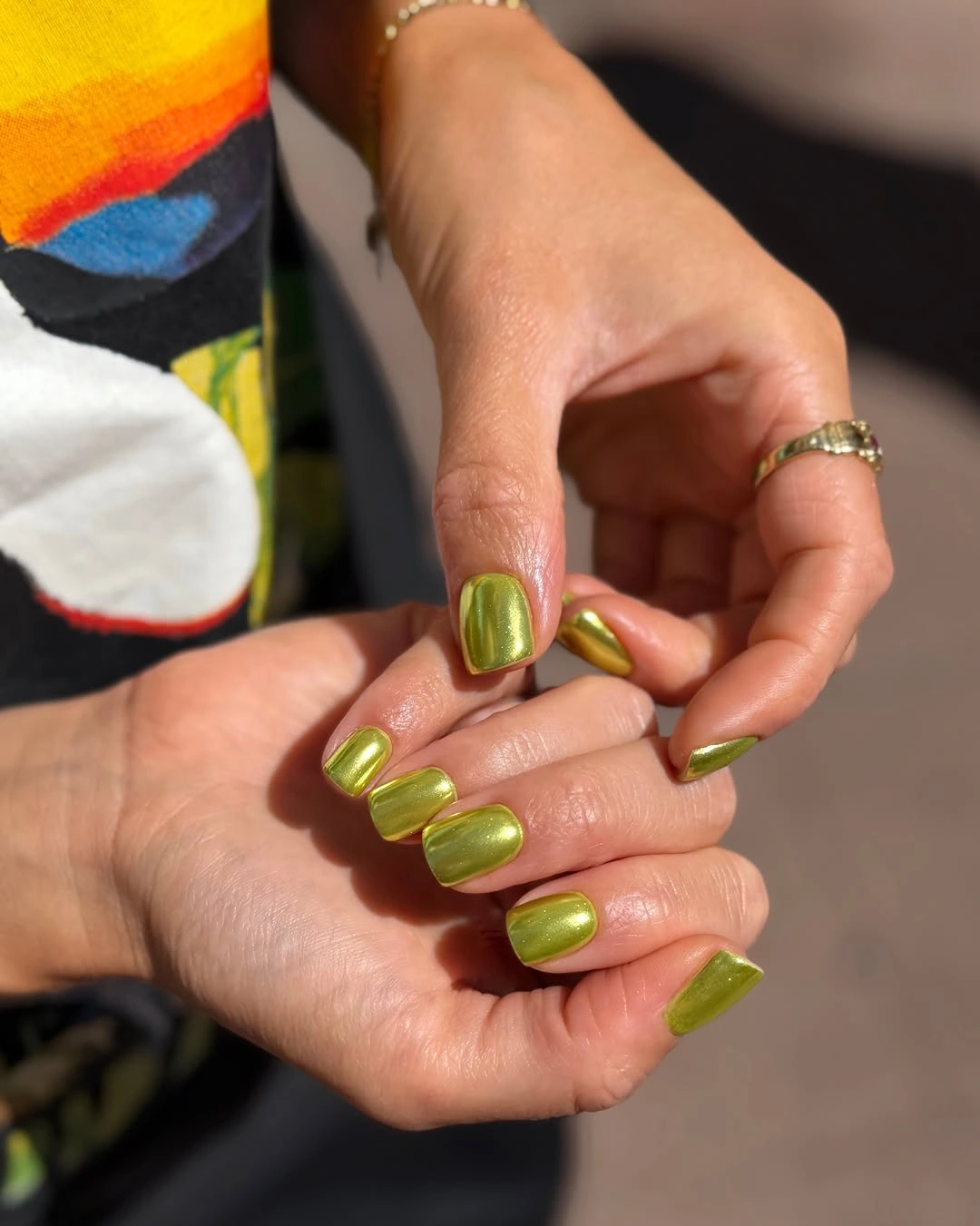 Glossy yellow green olive nails on a compact square shape
