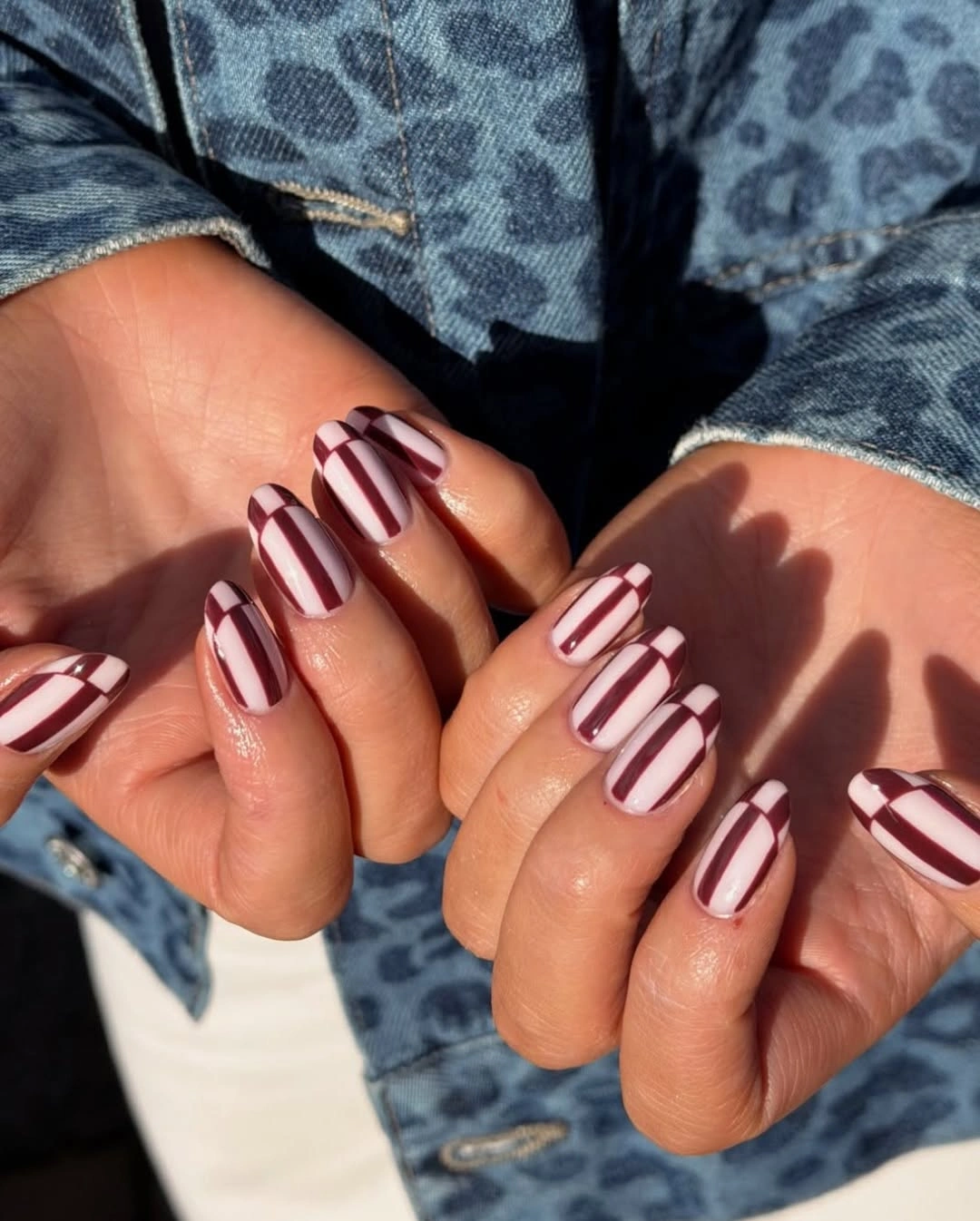 Compact square nails with burgundy and white vertical stripes