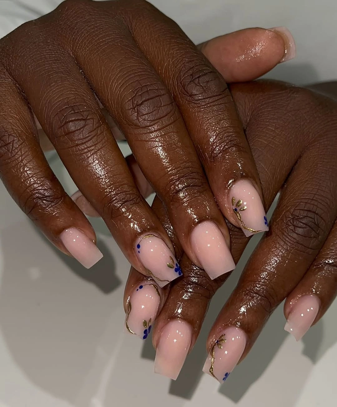 Blush square nails with gold vines and tiny blue florals