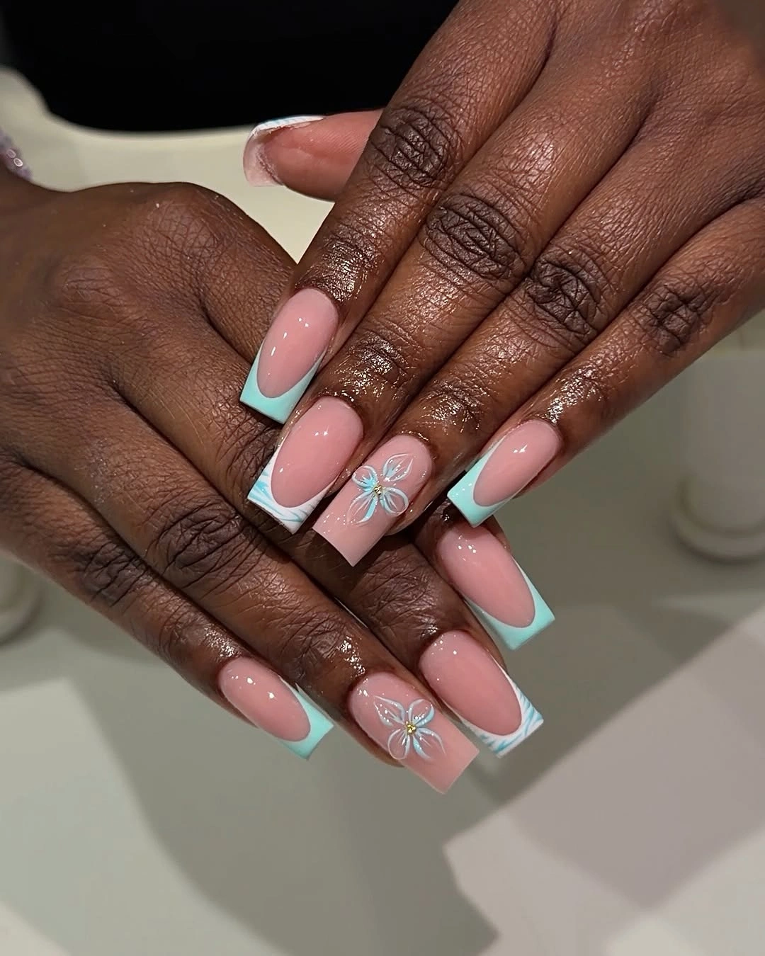 Mint French tips with pale floral accent nails