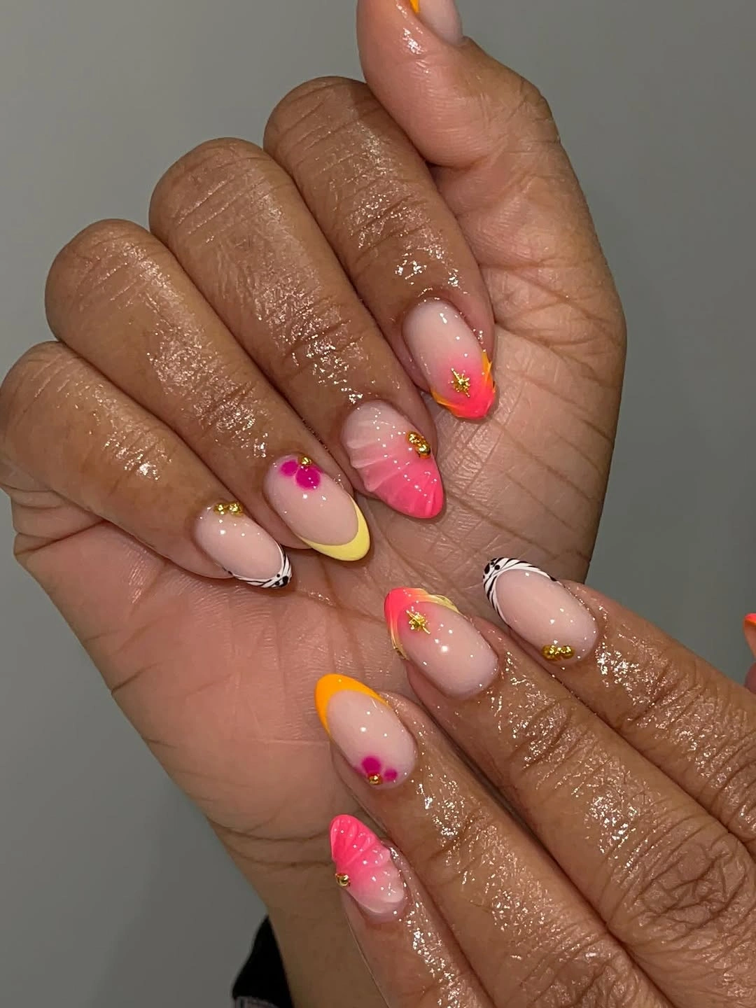 Almond nails with orange yellow and gold accents