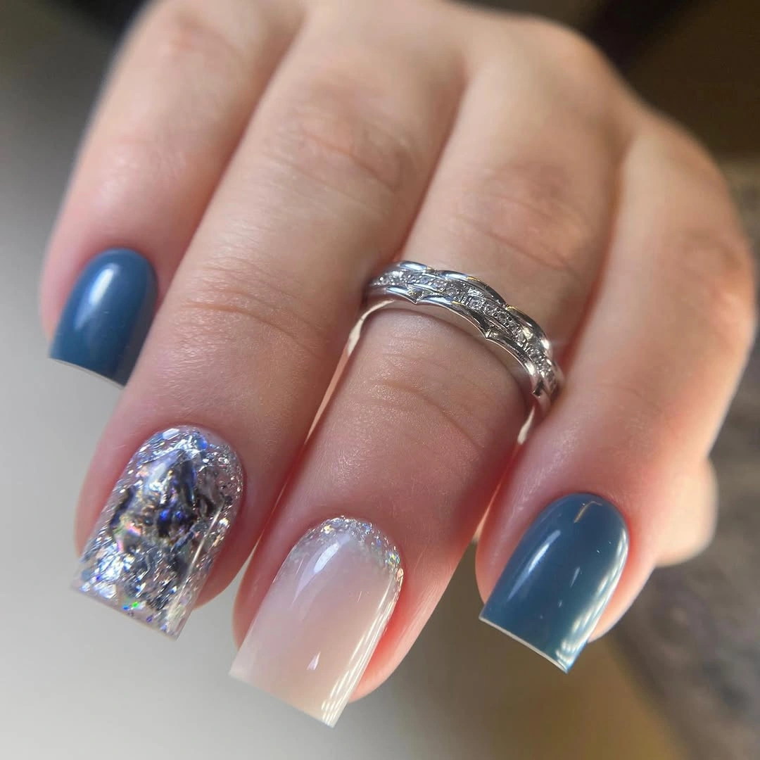 Short square nails with slate blue and one sparkling accent