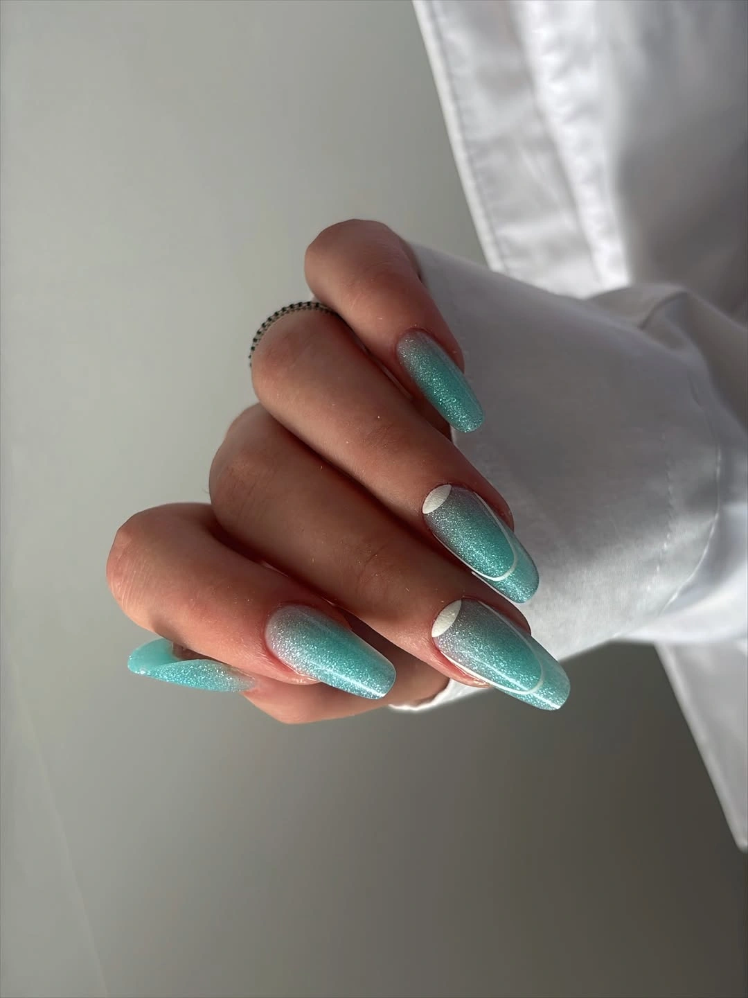 Long almond nails in glossy saturated turquoise blue green