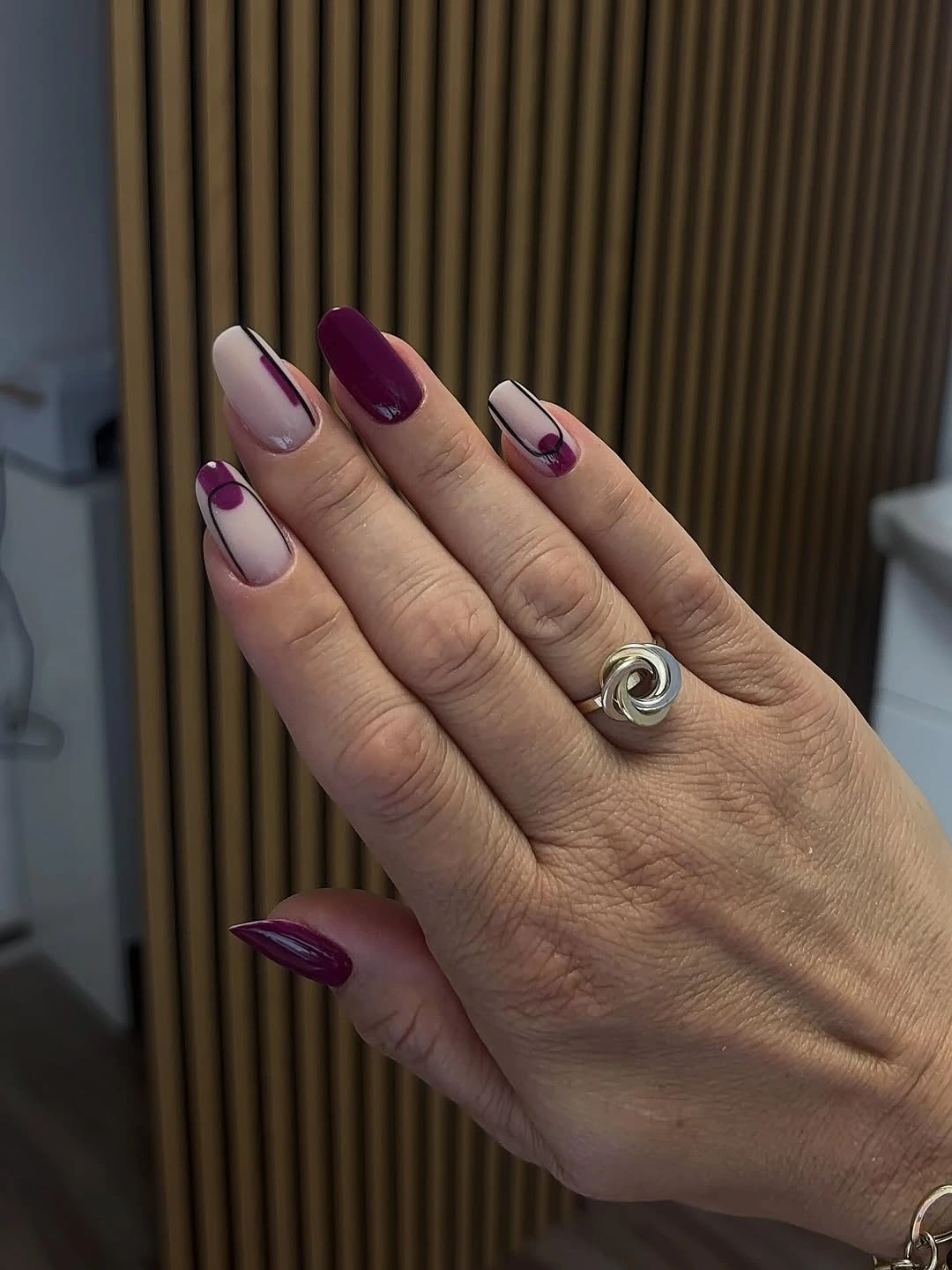 Long pointed nails with berry nude blocks and pink lines