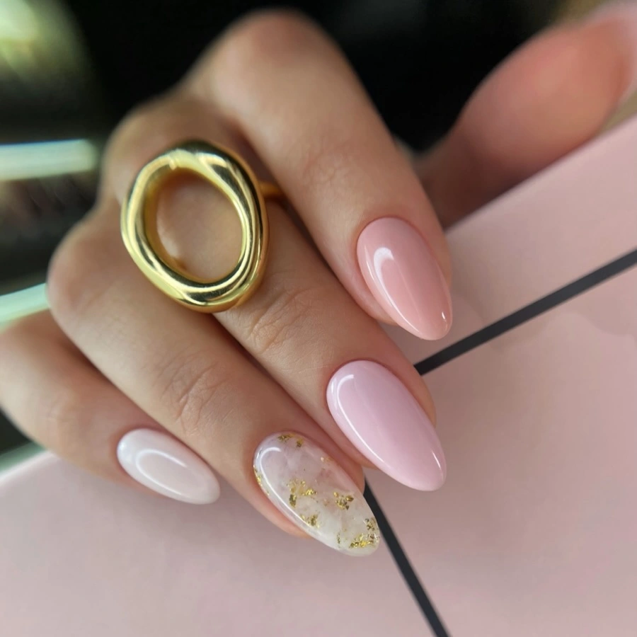 Medium blush almond nails with one delicate floral accent