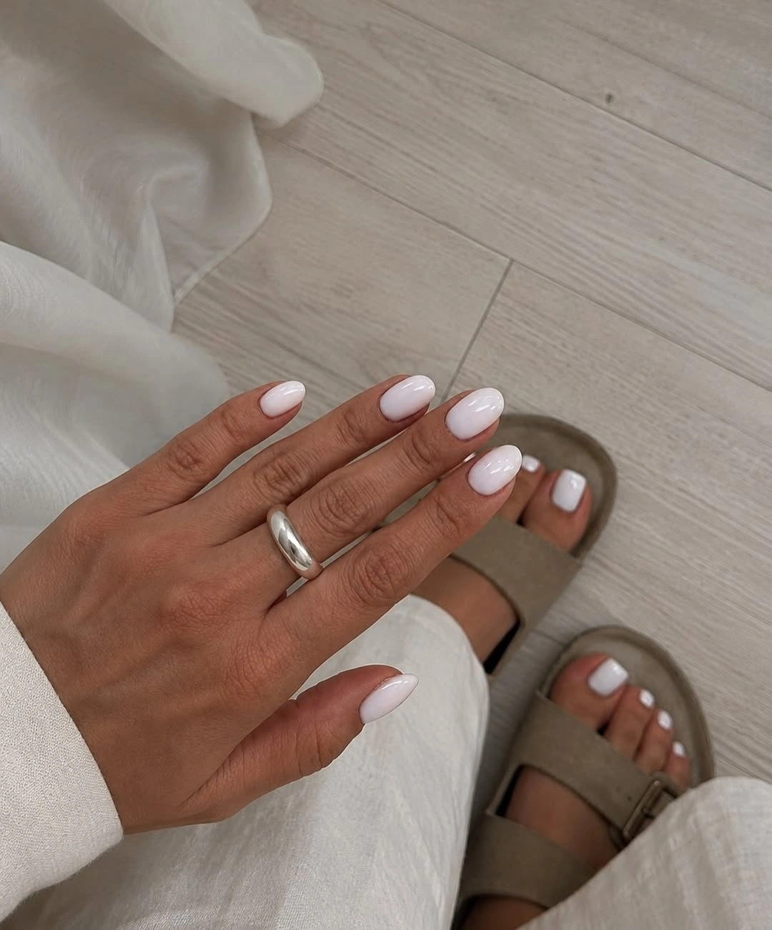 Milky white rounded-square nails with a clean neutral finish