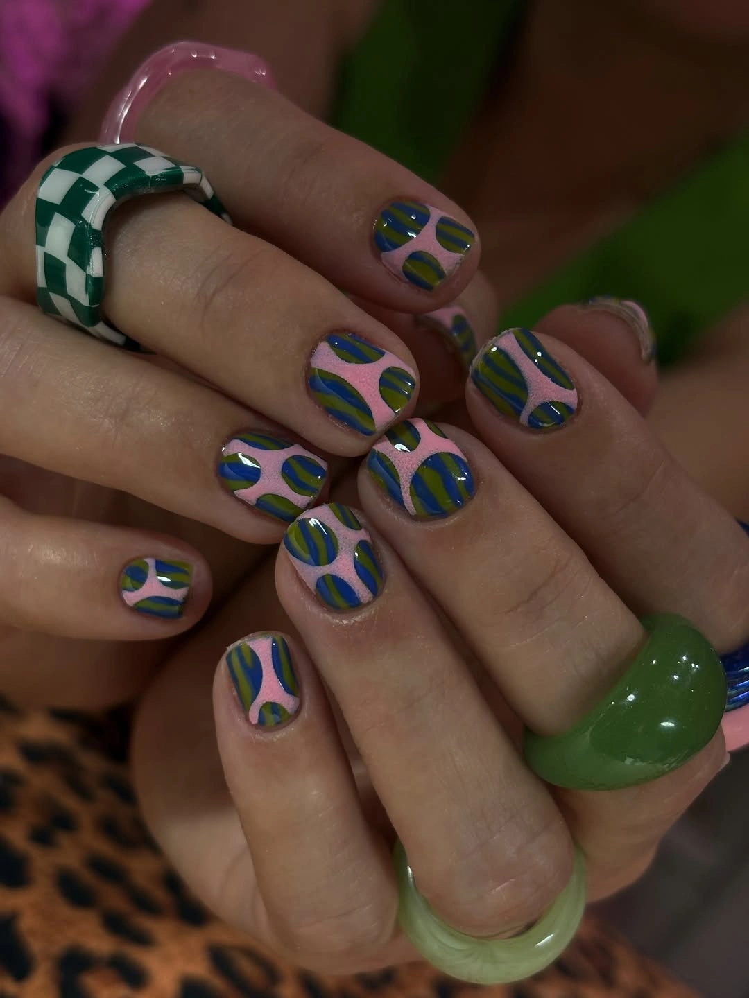 Green blue and white wavy nails on a short shape
