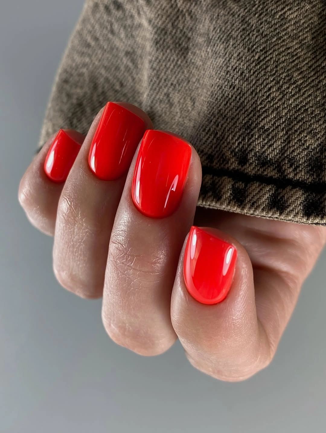 Short bright red square nails with glossy reflection