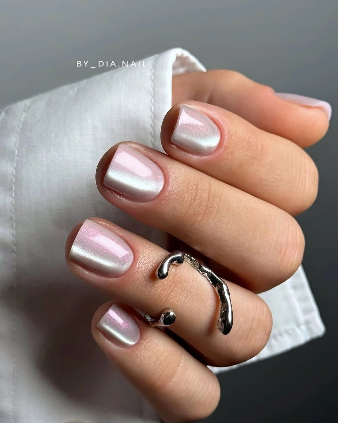 Pearly blush-pink rounded-square nails with bright reflection