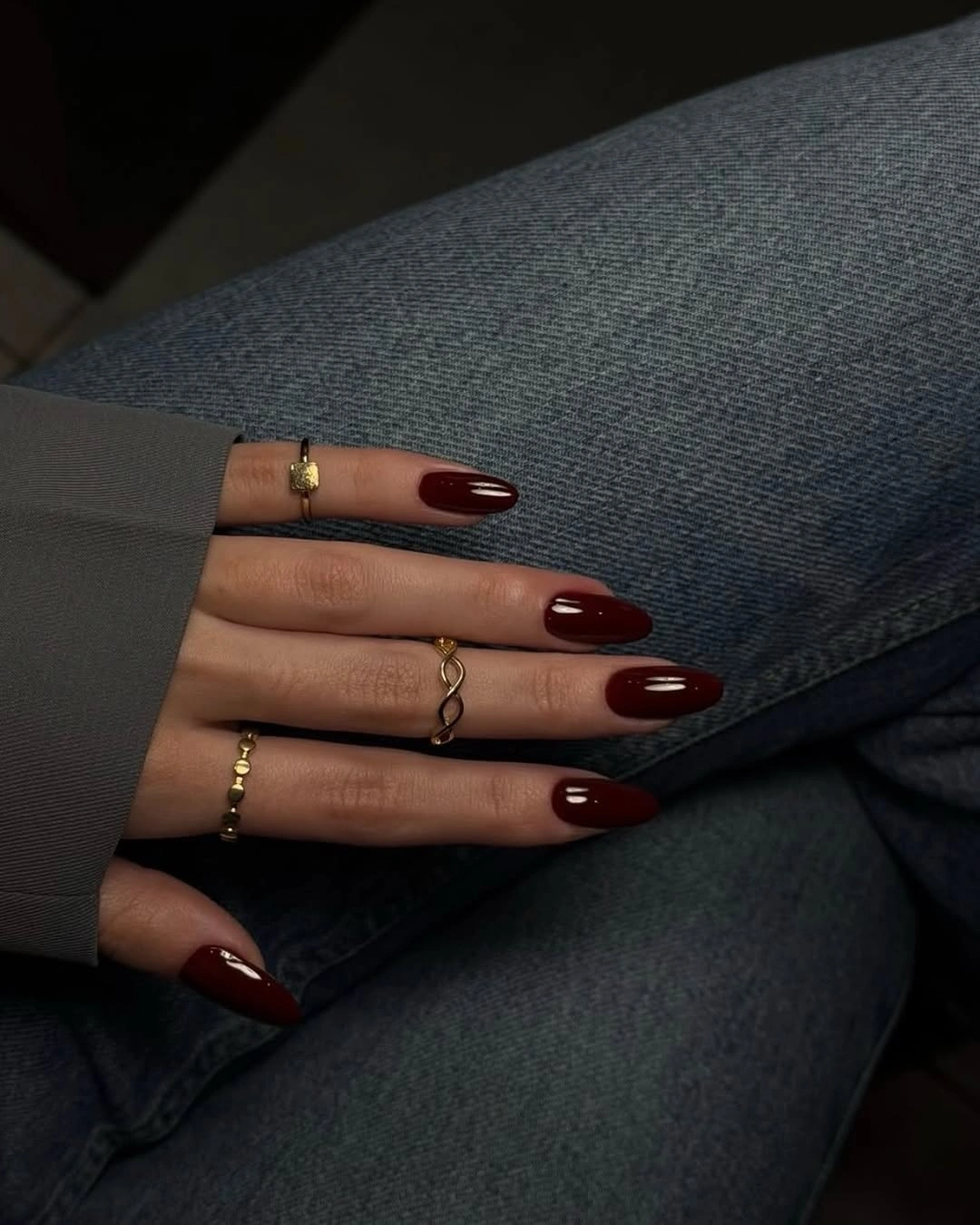 Long almond nails in a deep wine shade