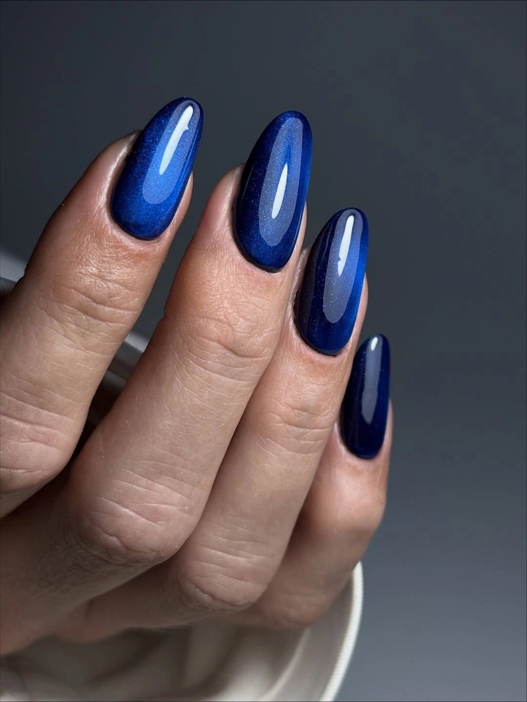 Long almond nails in deep glossy cobalt blue