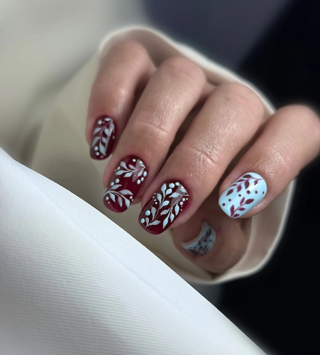 Short burgundy nails with white floral line accents