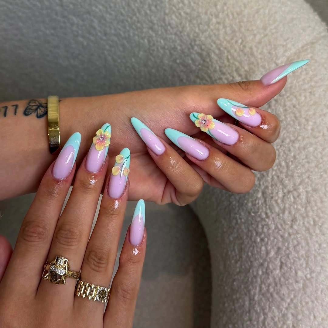 Long pink almond nails with cool pastel tips and tiny flowers