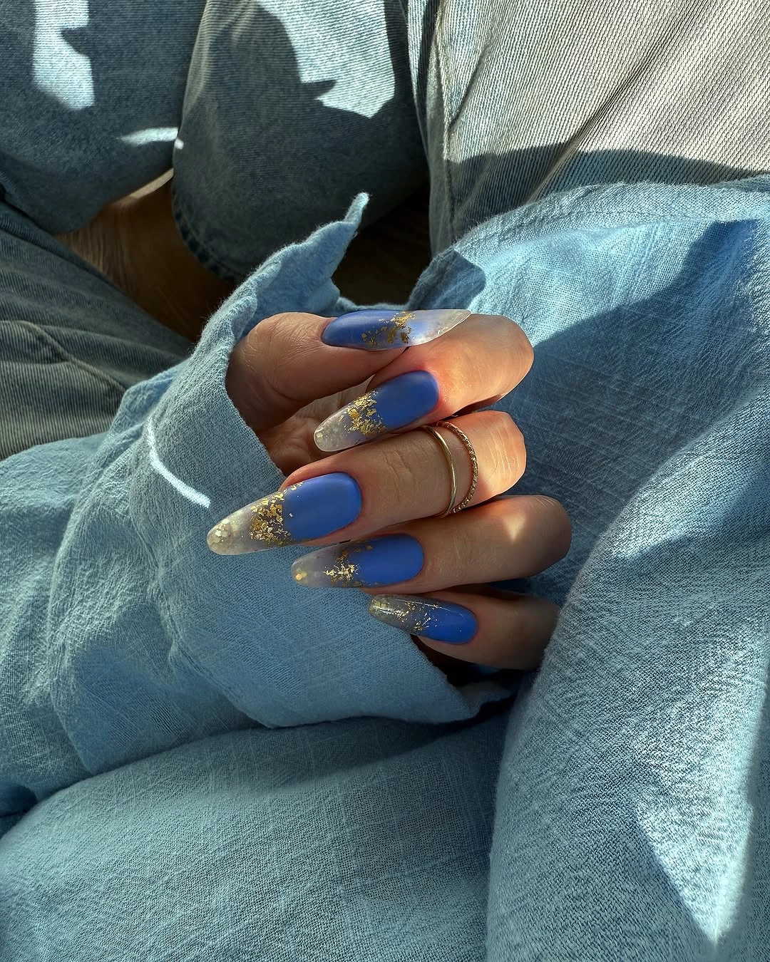 Long cobalt blue almond nails with selective gold accents