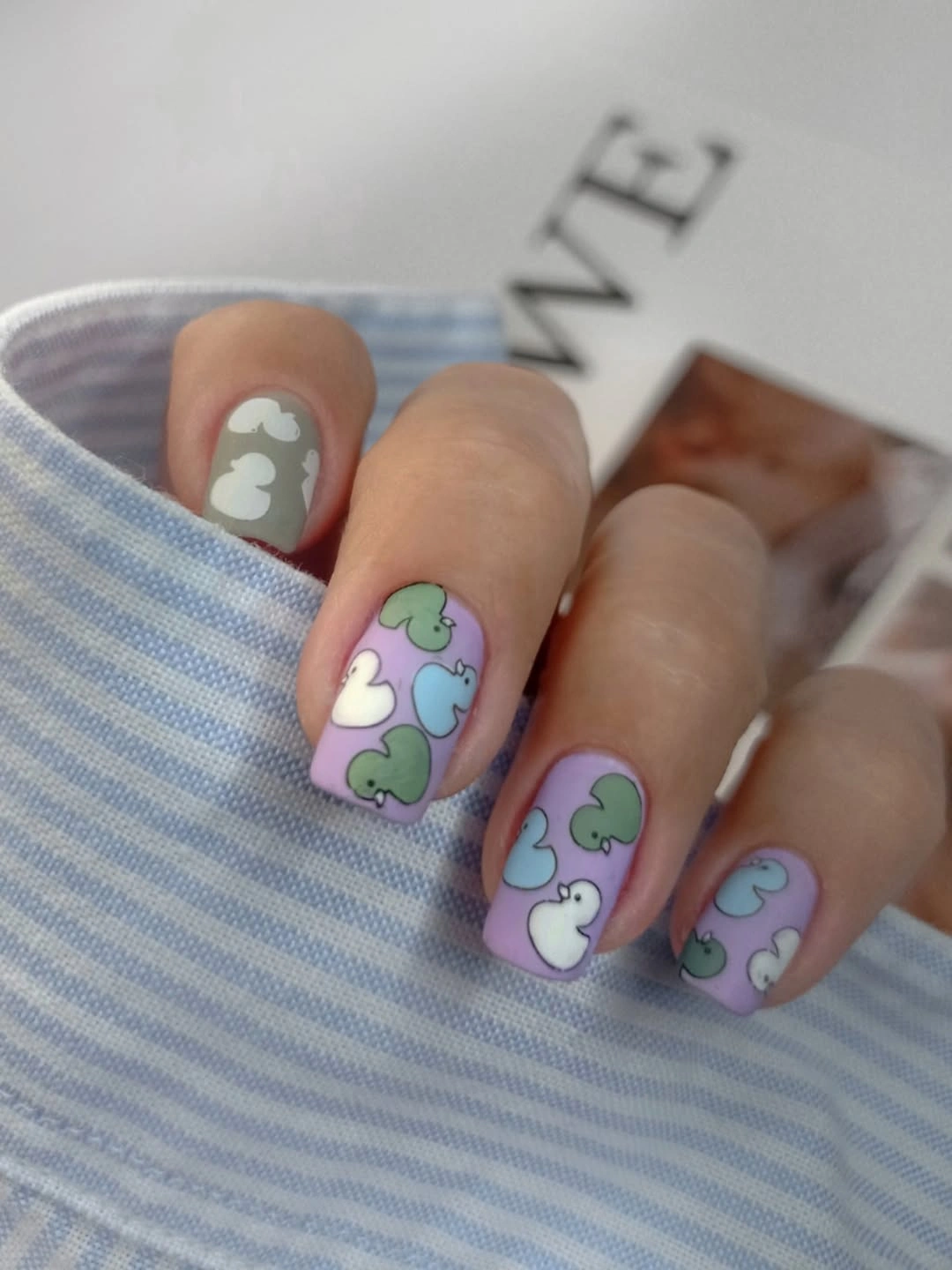 Pastel square nails with colorful illustrated accents