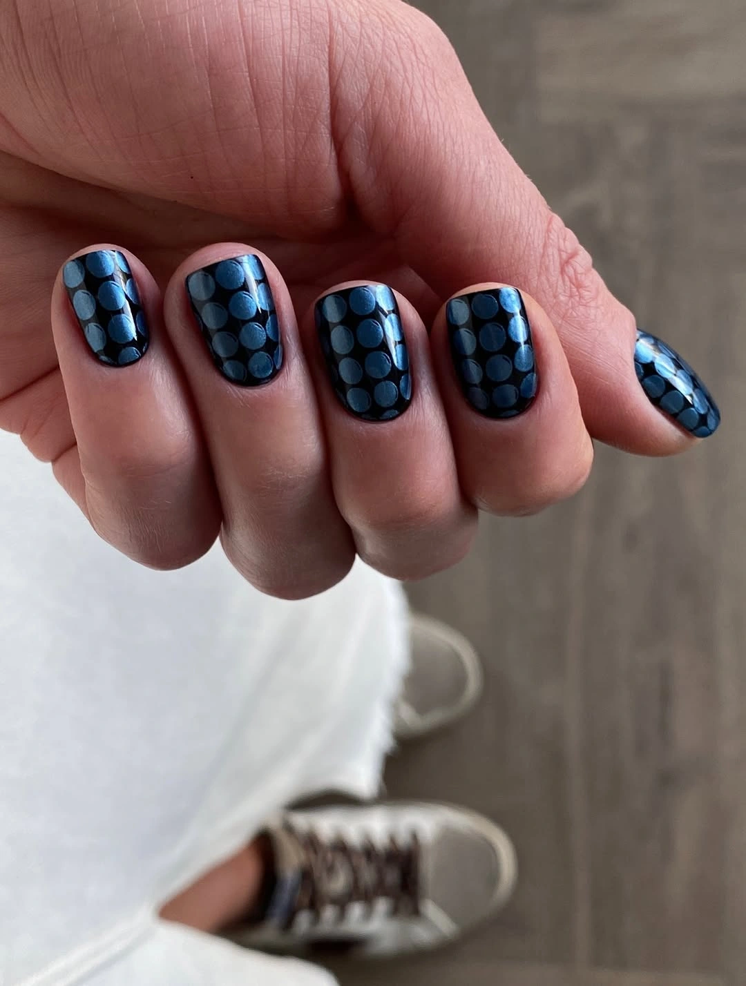 Short blue square nails with dark grid pattern accents