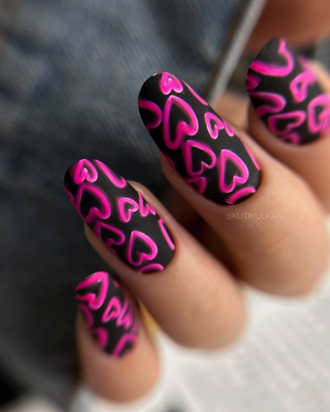 Black matte square nails with hot-pink heart accents