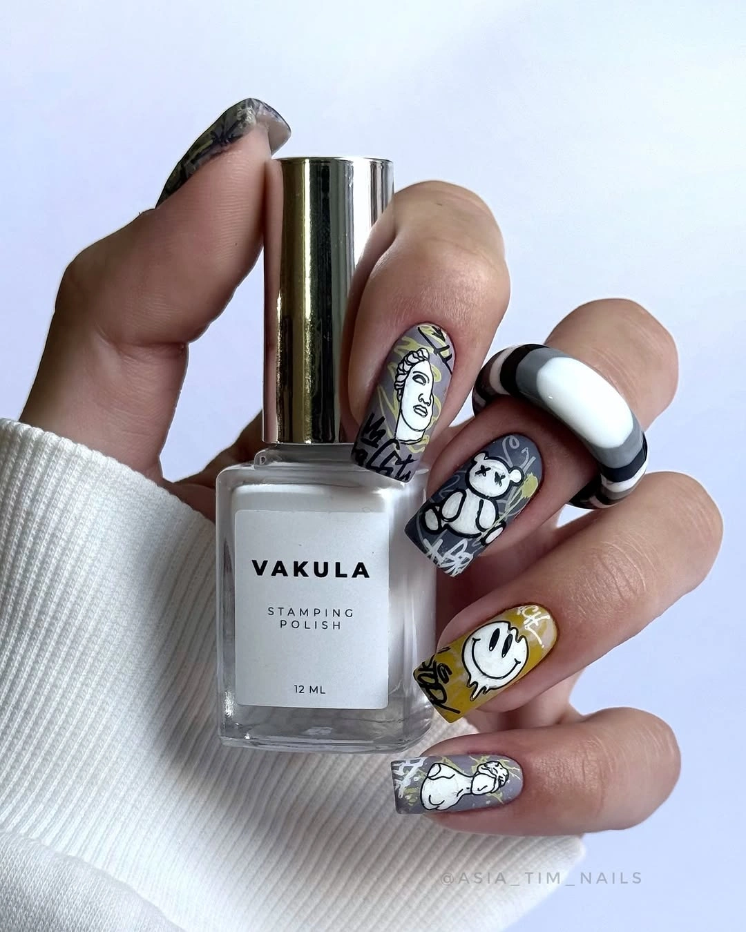 Black white square nails with colorful illustrated accents