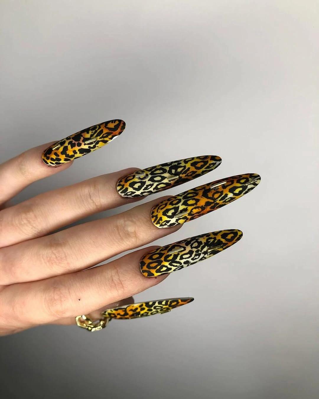 Long yellow leopard-like nails with one solid accent