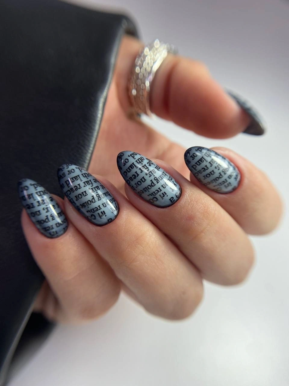 Smoky gray almond nails with repeated dark grid marks