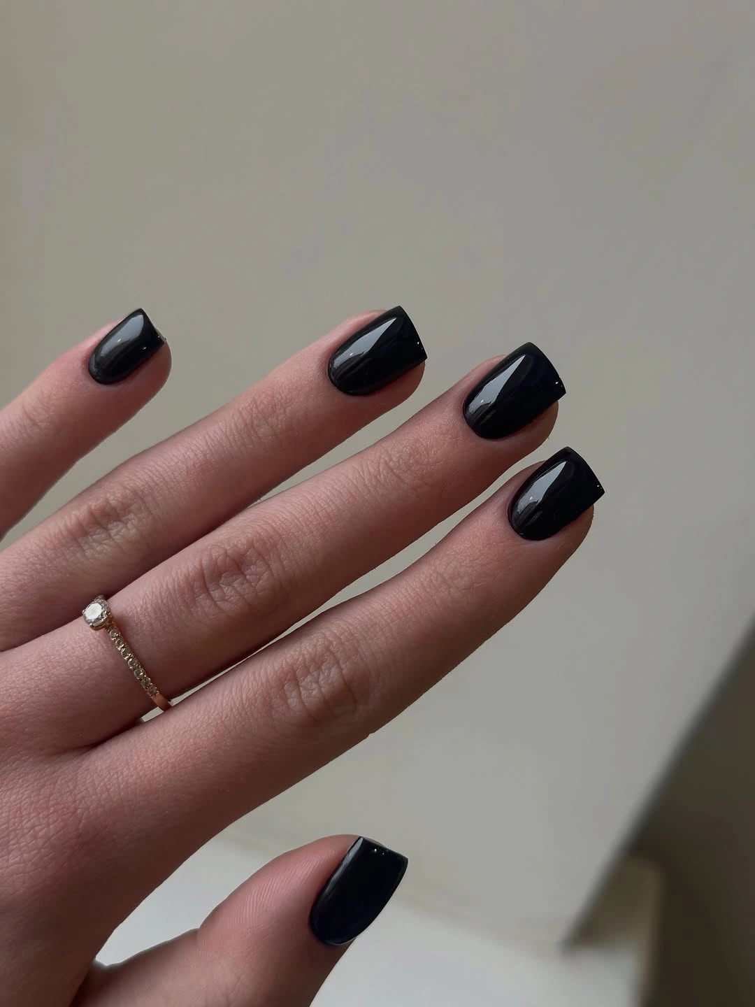 Medium glossy black almond nails with sleek pointed tips