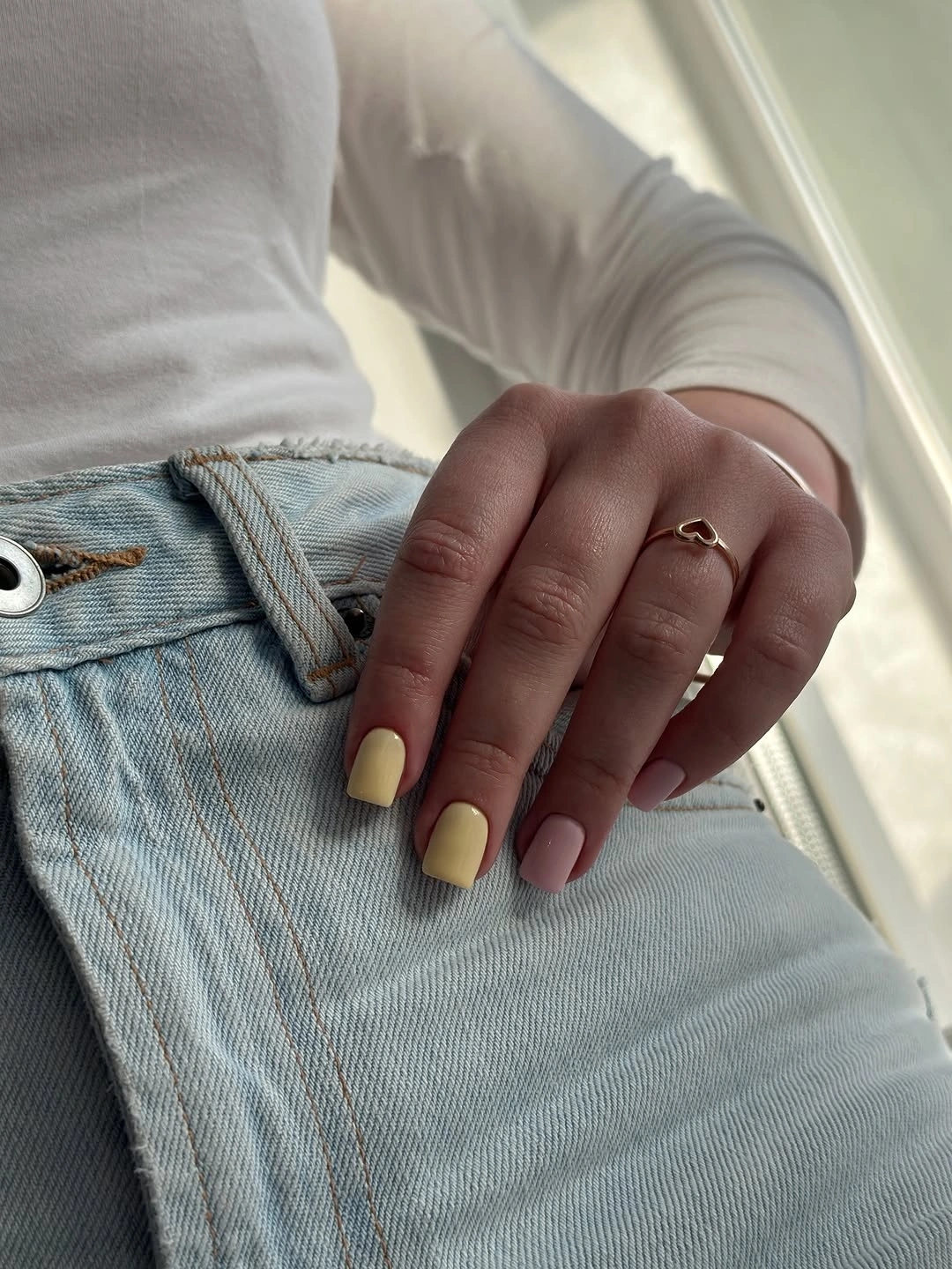 Square nails in a pale creamy yellow autumn-neutral color