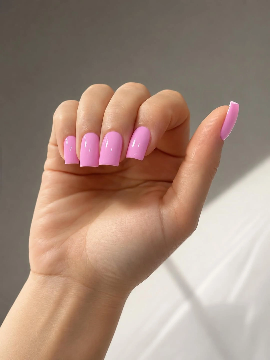 Medium glossy square nails in a saturated bright pink shade