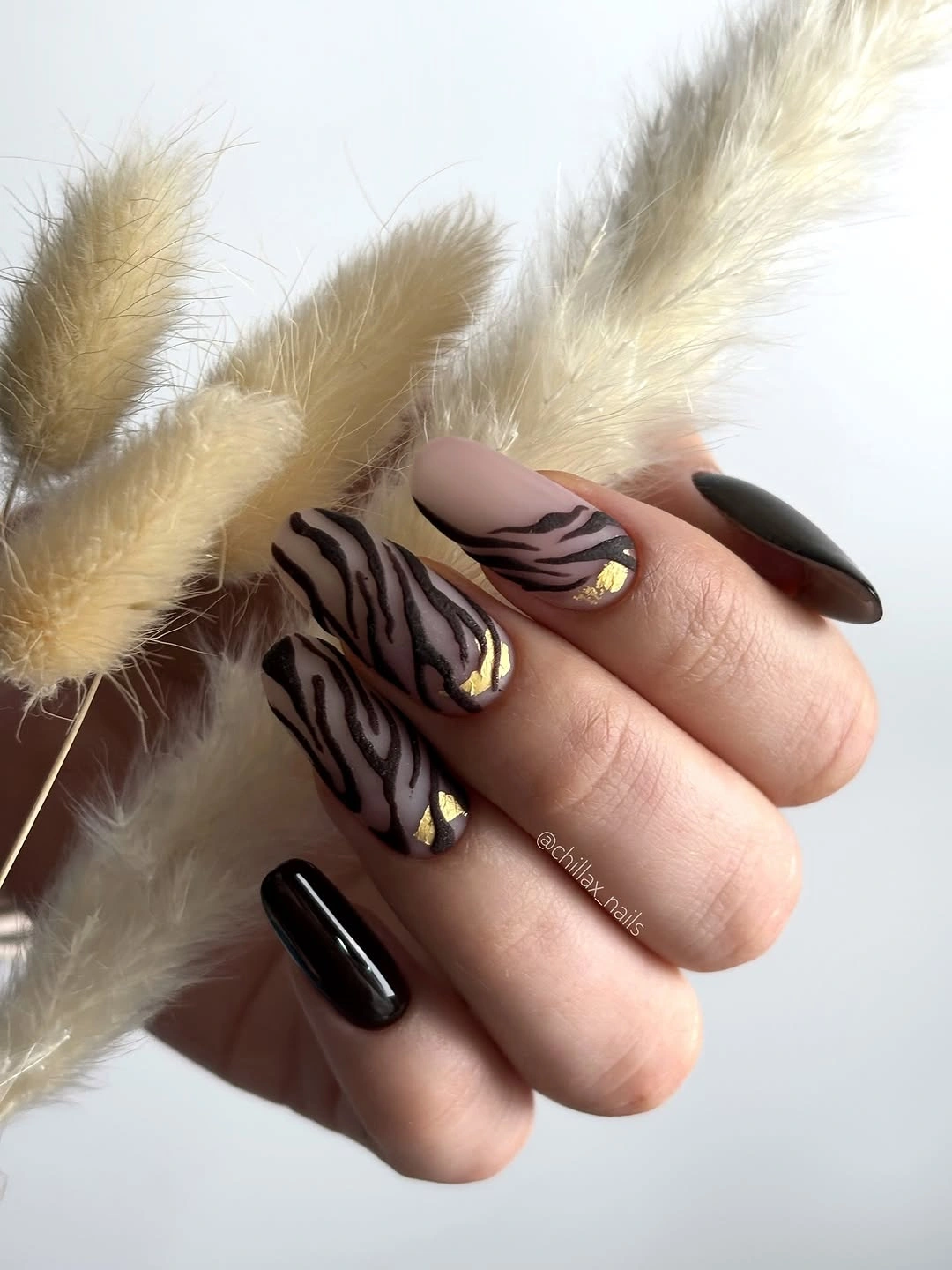 Long almond brown black nails with earthy diagonal stripe accents