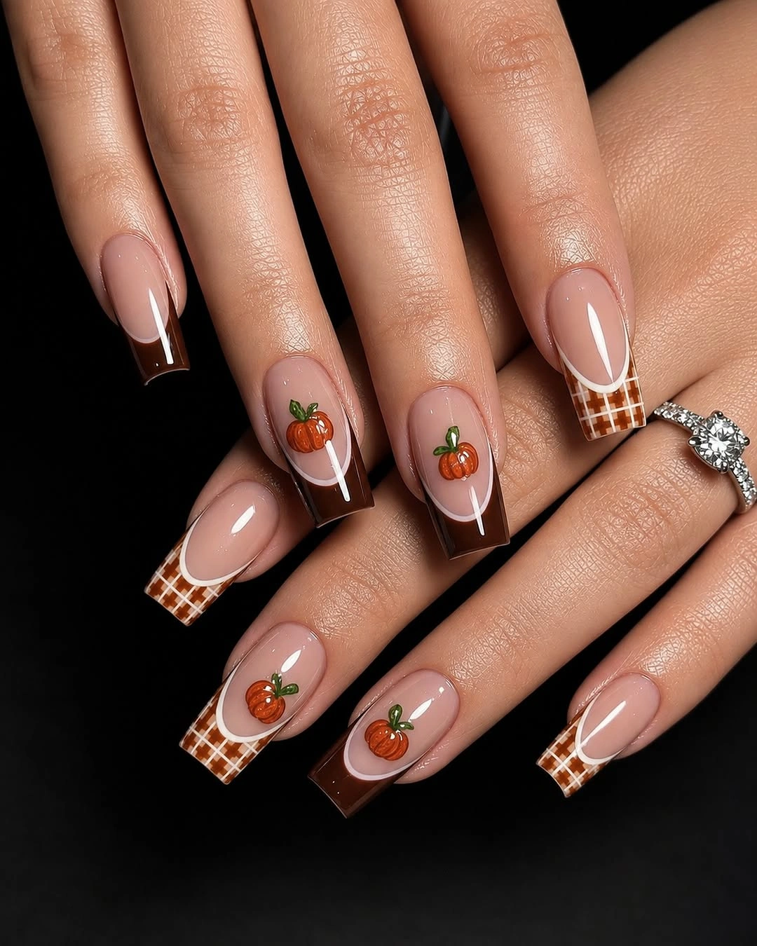 Long coffin nude nails with brown checkerboard tips and pumpkins