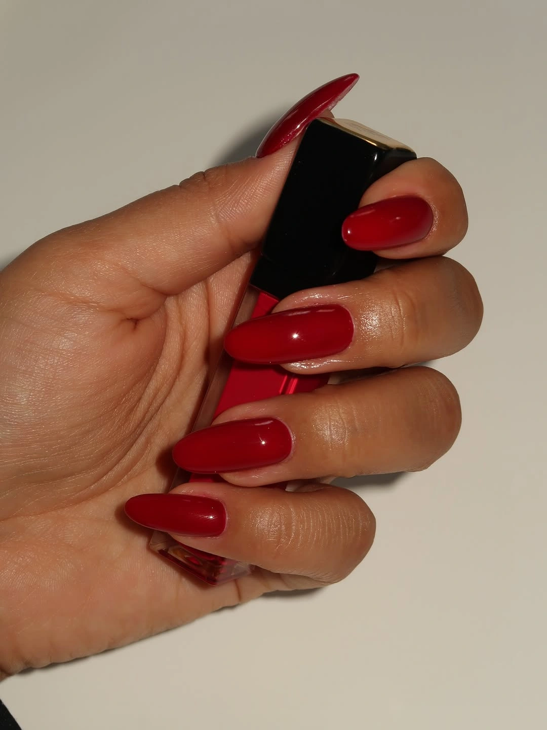 Warm deep glossy red almond nails
