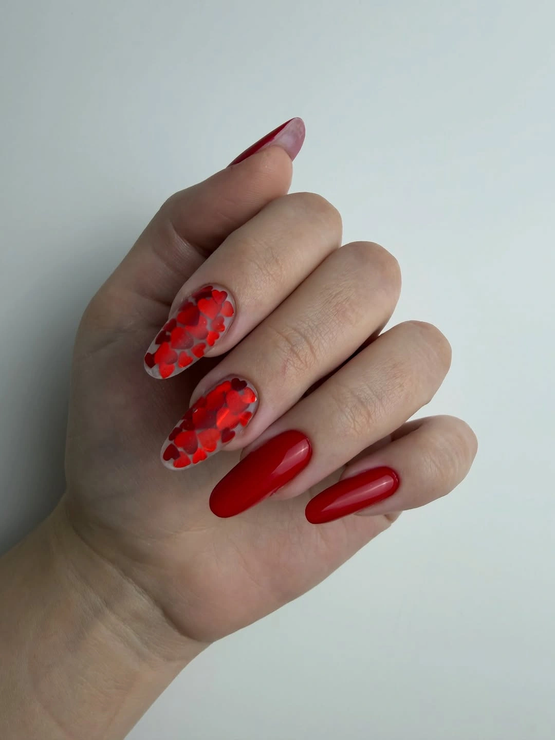 Red almond nails with heart accents