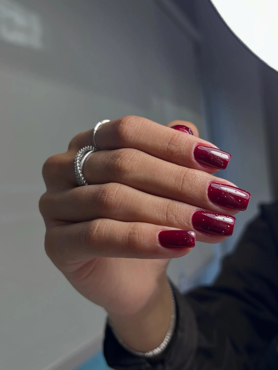 Short burgundy square nails with fine sparkle