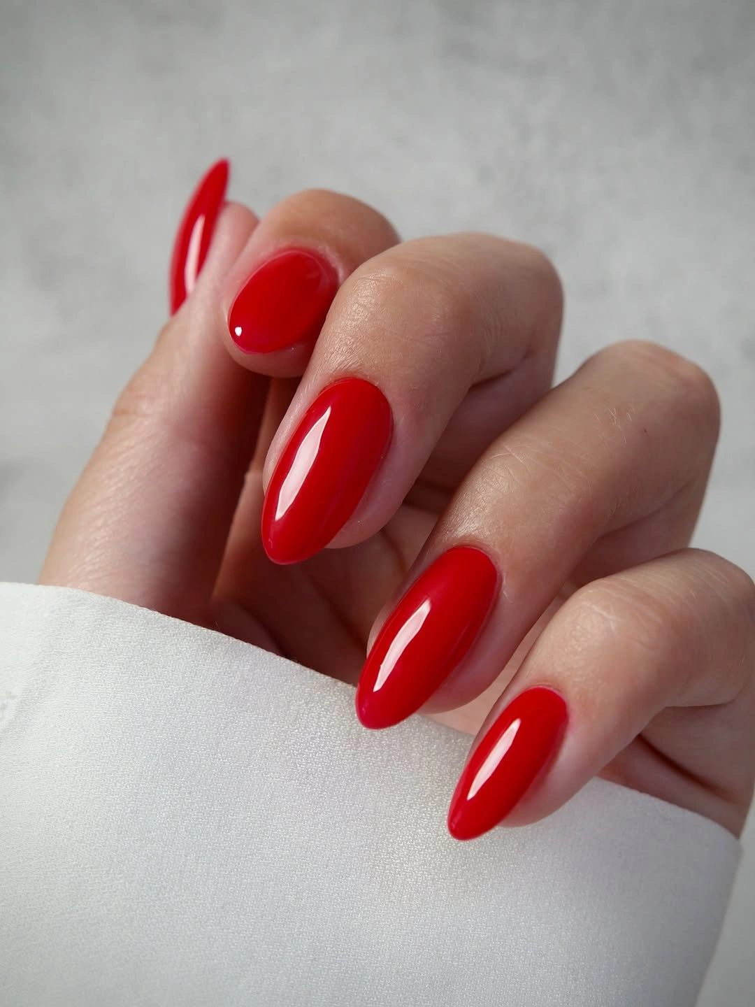 High-shine glossy red almond nails