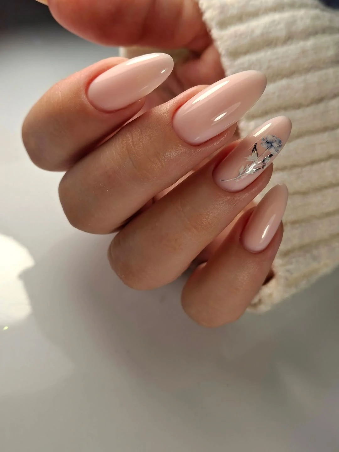 Soft nude almond nails with blue black silver and white accents