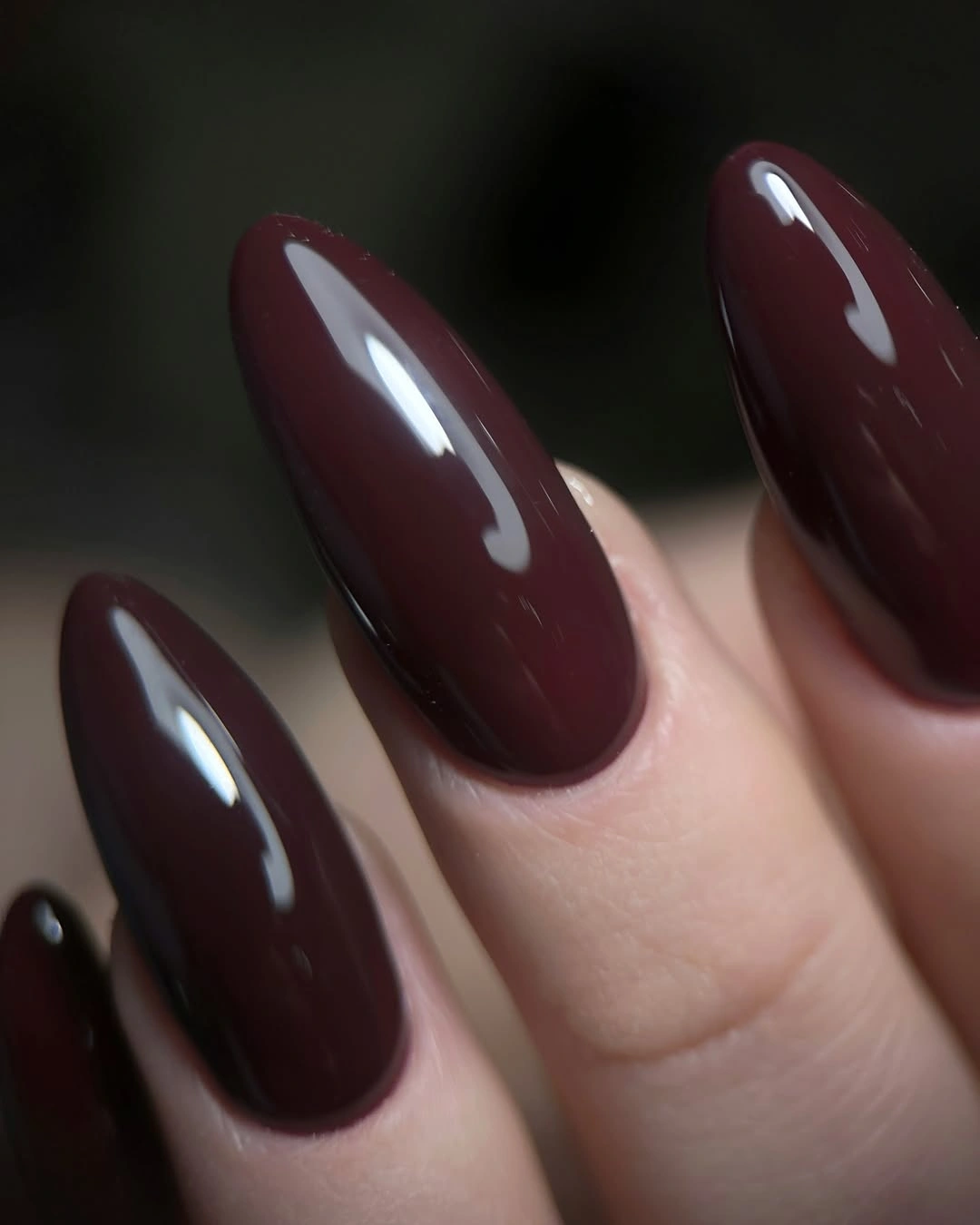Long almond nails in dark burgundy gloss with berry highlights