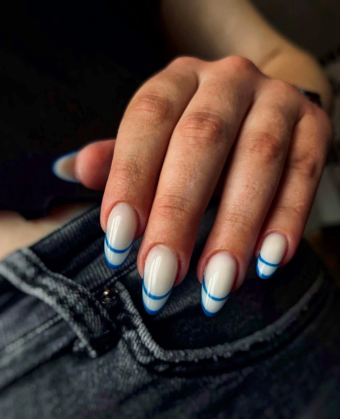 Milky almond nails with clean cobalt blue French tips