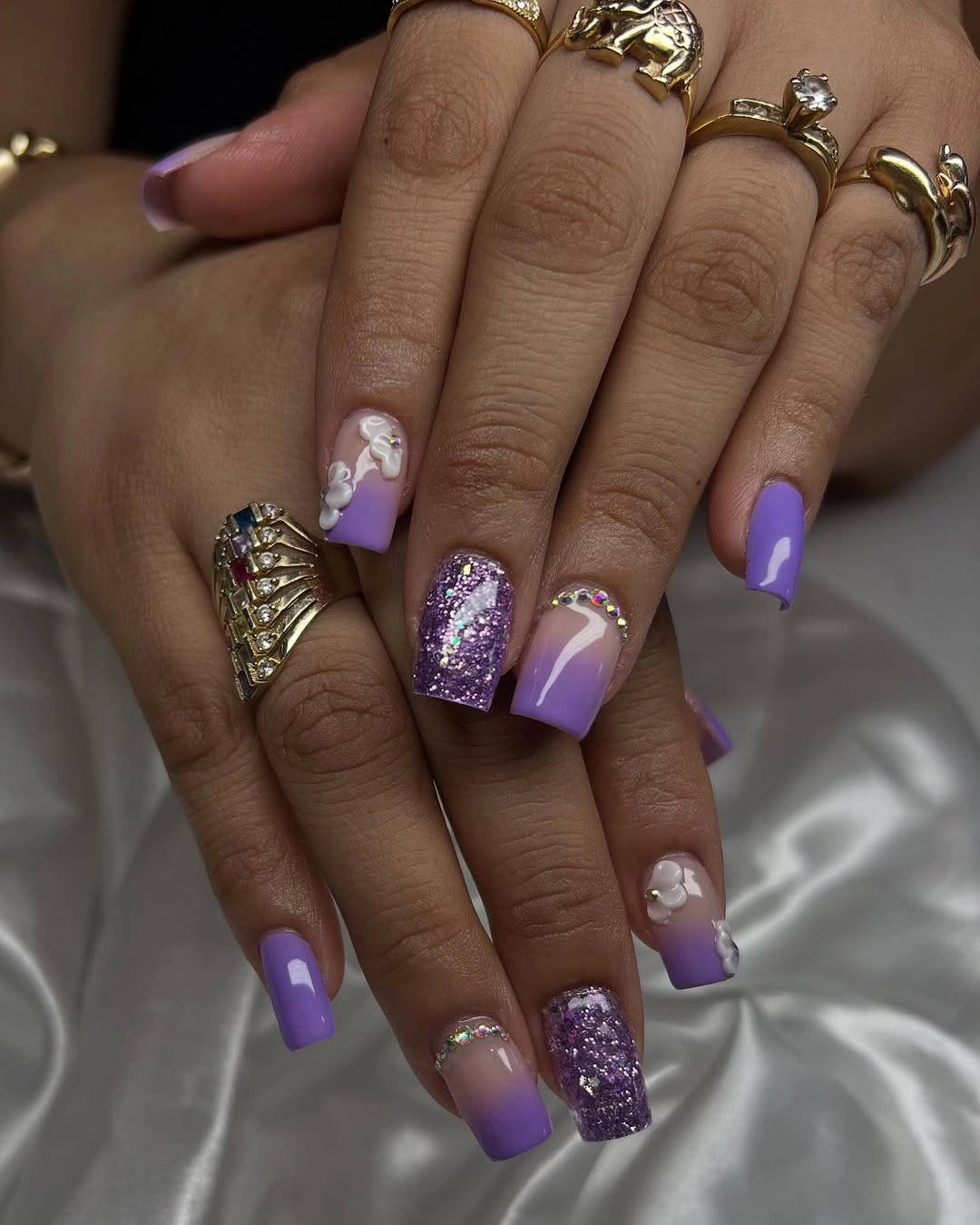 Lavender square nails with purple glitter and floral accents