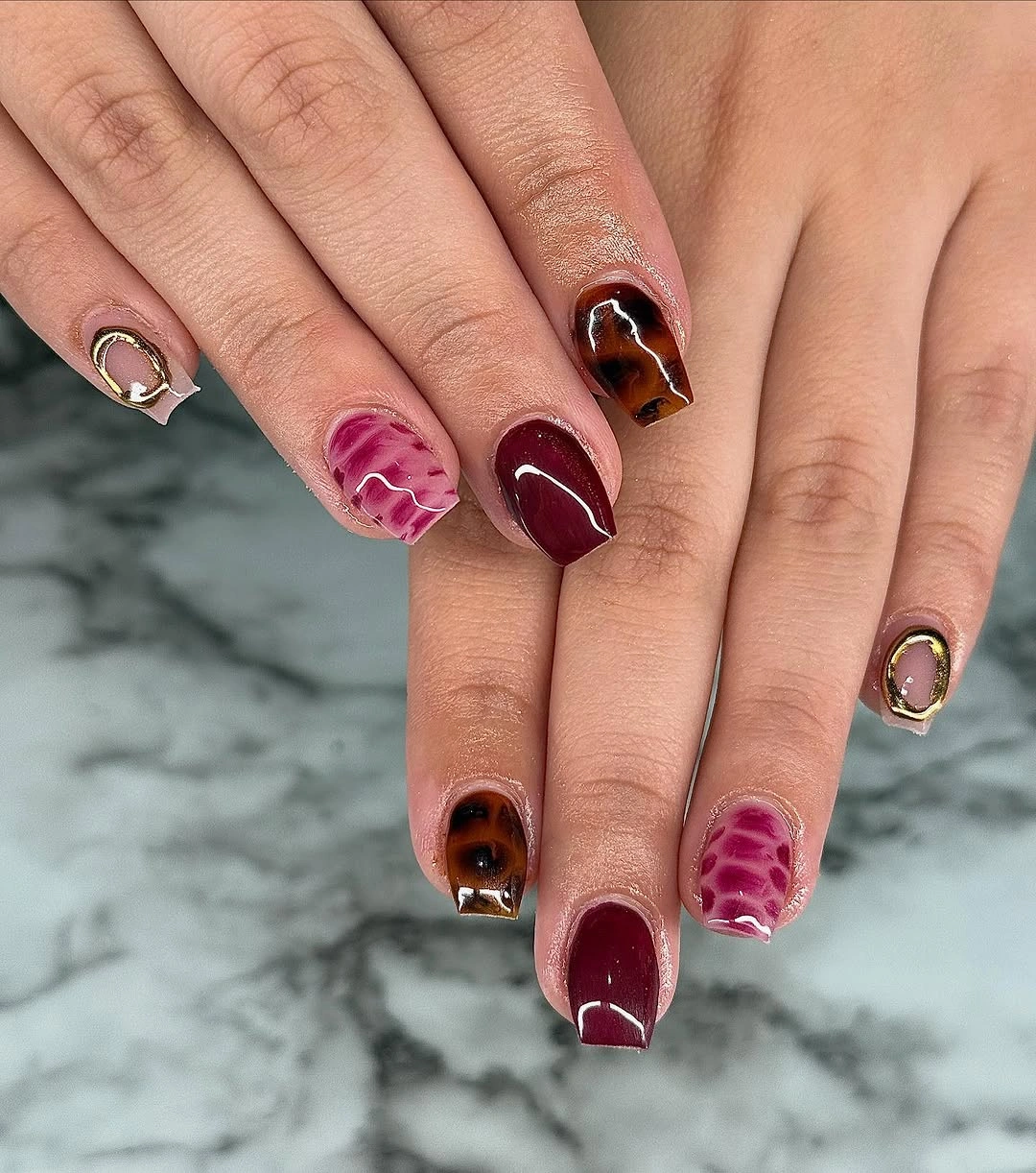 Burgundy square nails with textured pink and brown accents