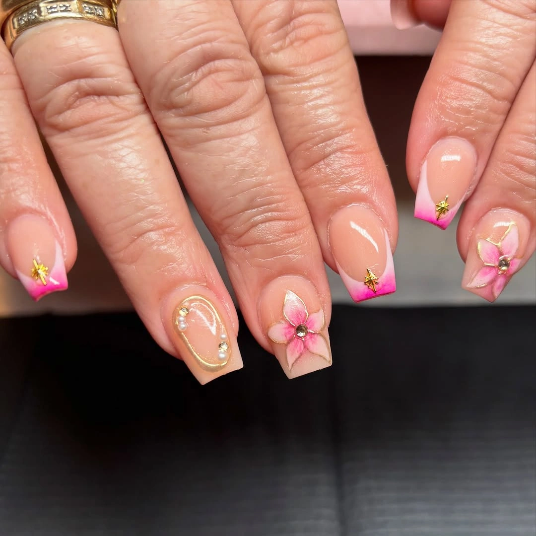 Pale pink square nails with fuchsia tips and floral accents