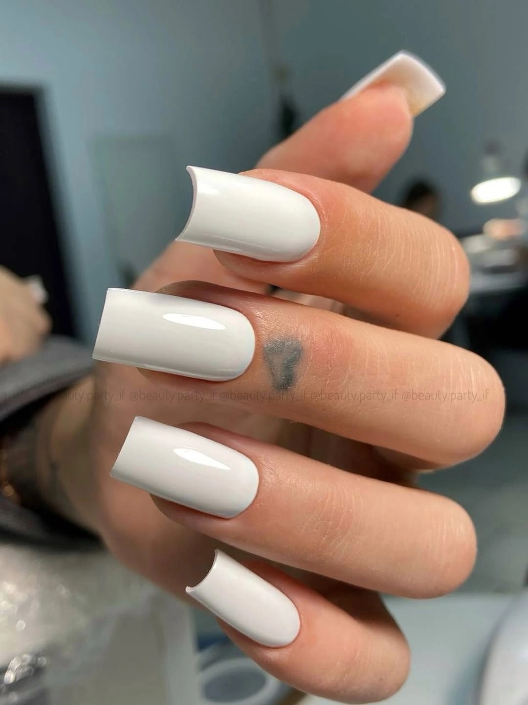 Long square nails in opaque glossy white polish