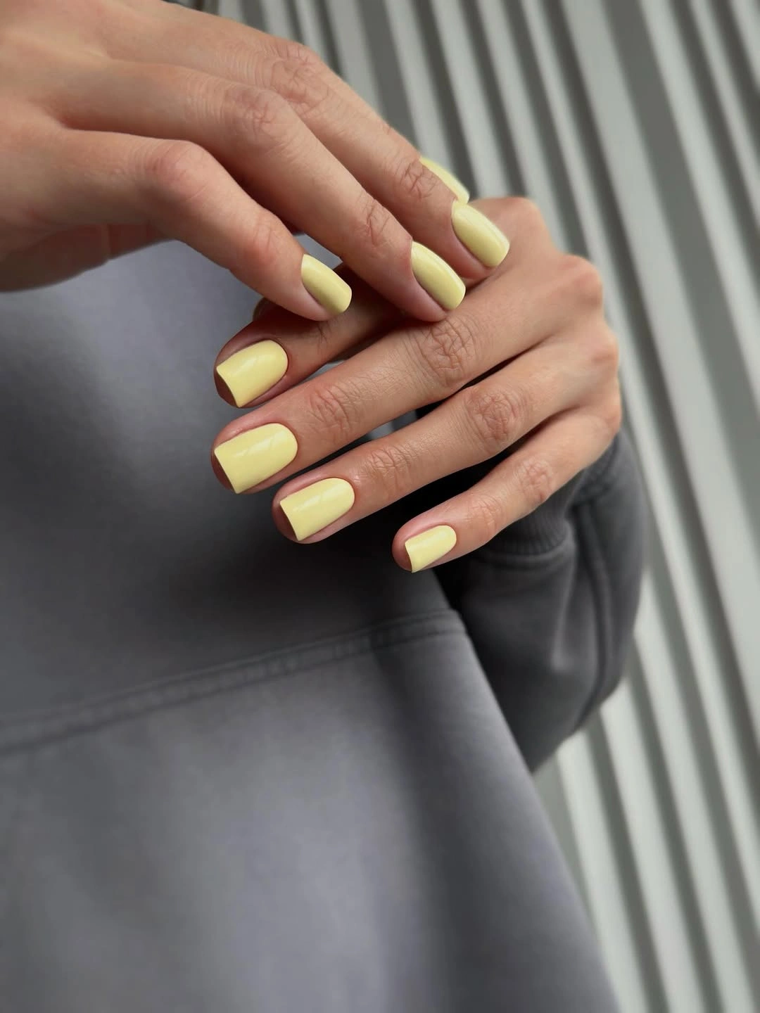 Short square nails in soft buttery yellow polish