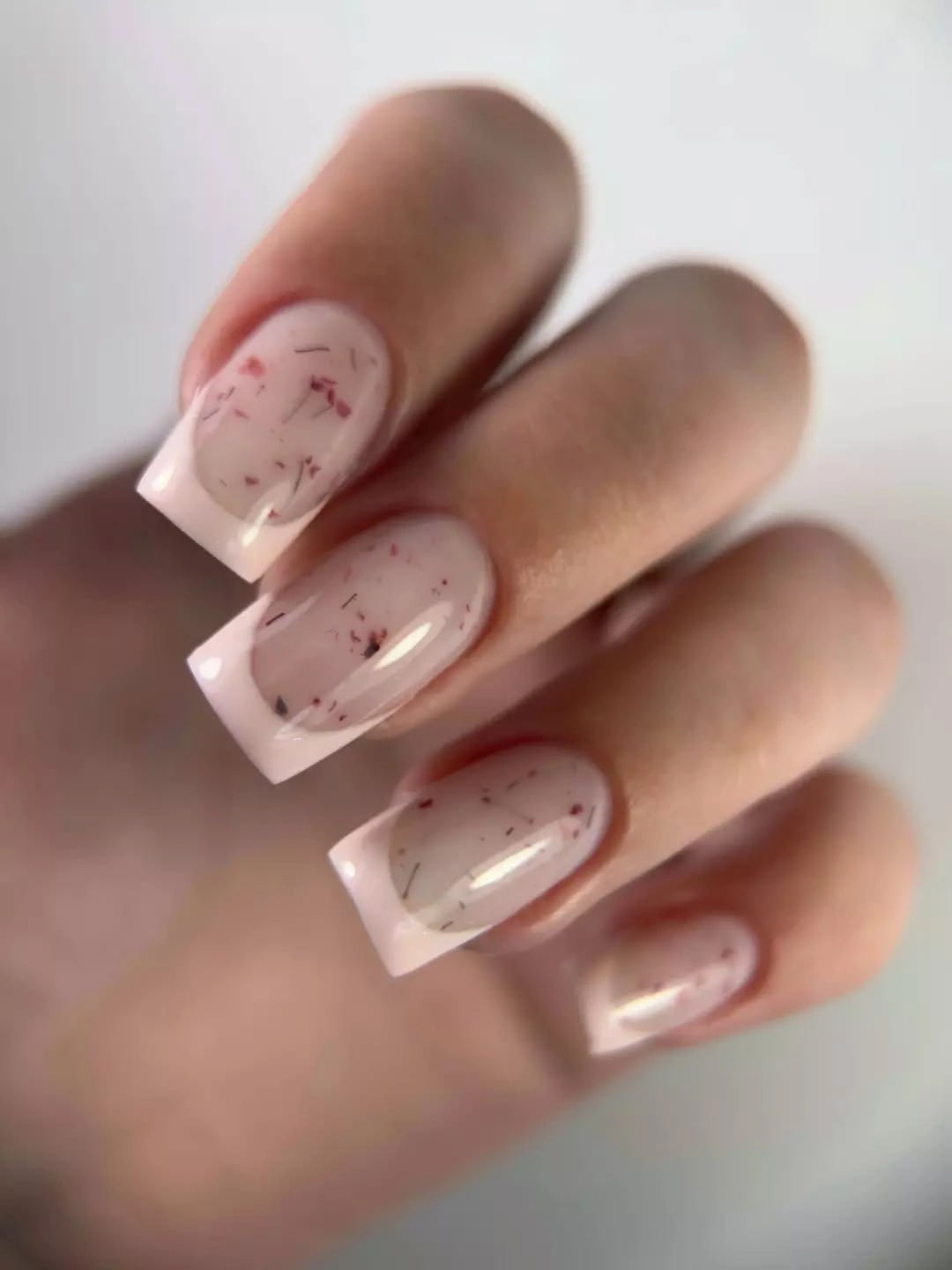 Medium square sheer nude nails with delicate warm flecks