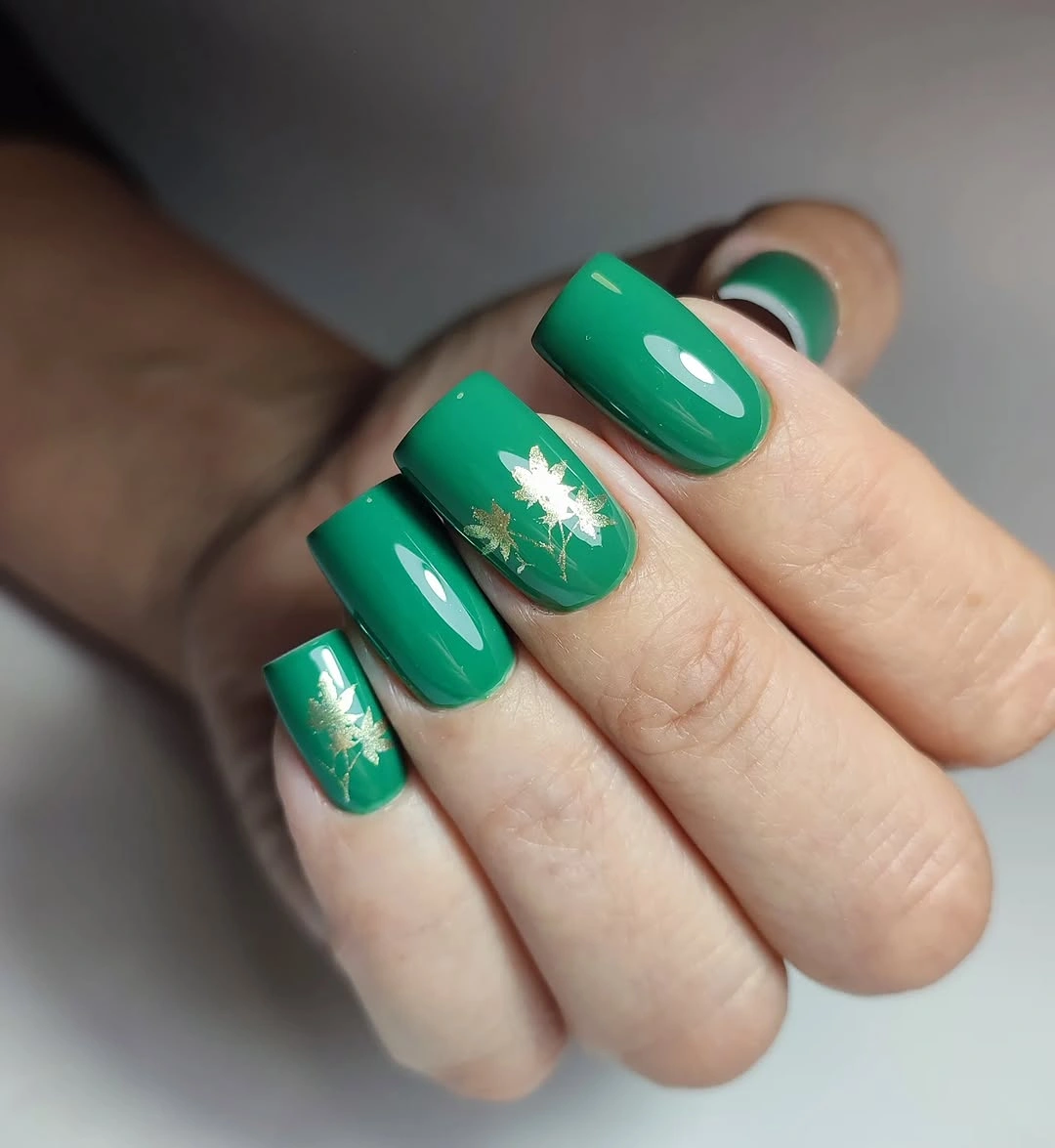 Medium green square nails with small white floral accents