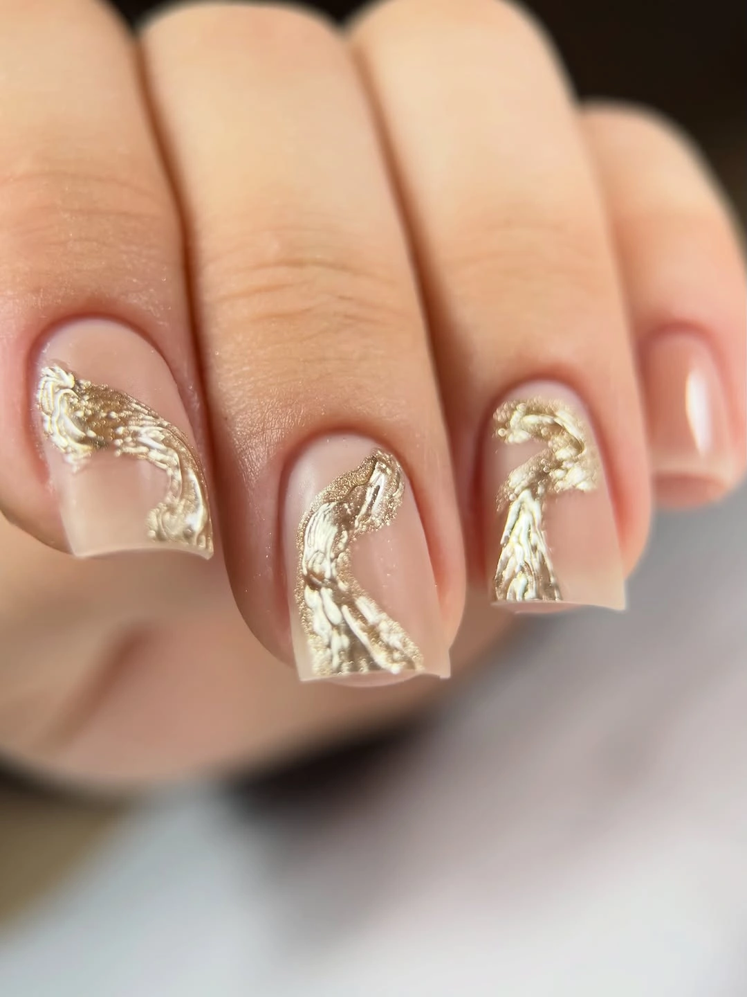 Medium sheer nude square nails with scattered gold foil accents