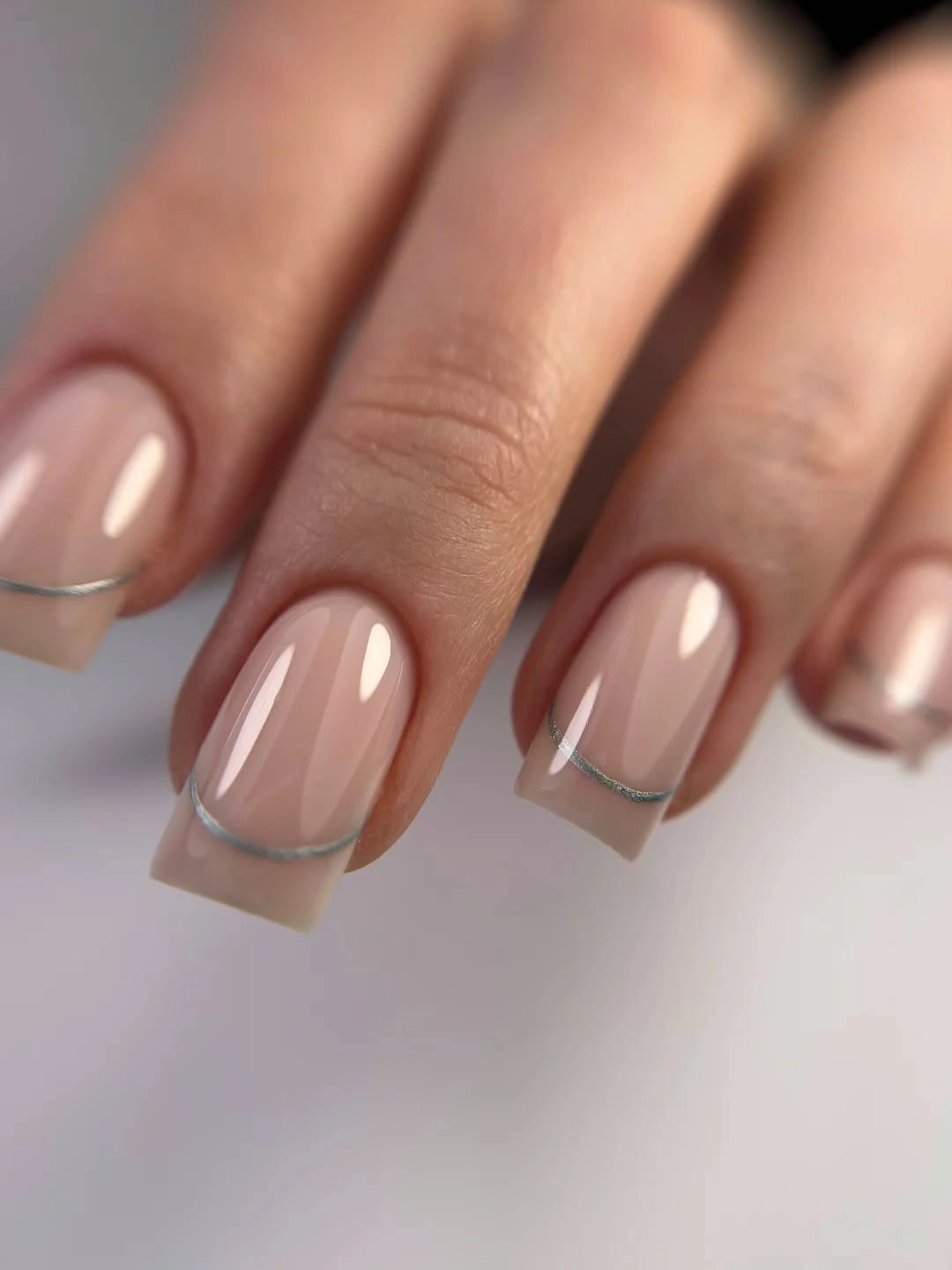 Short sheer nude square nails with thin silver edge lines