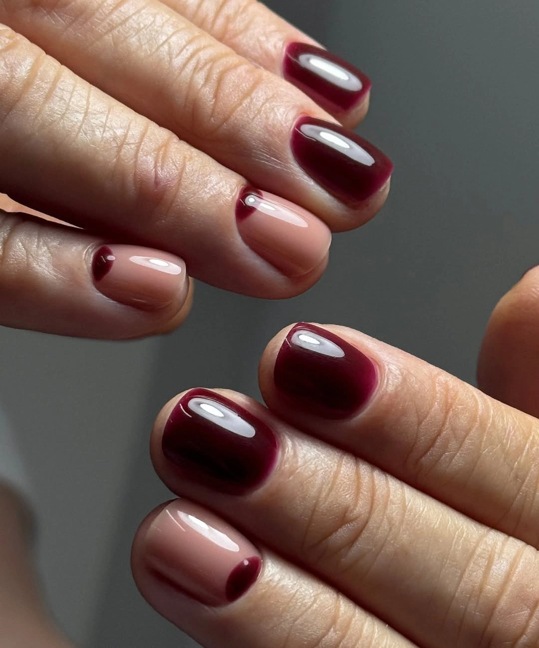 Short rounded square nails with burgundy curved edge accents