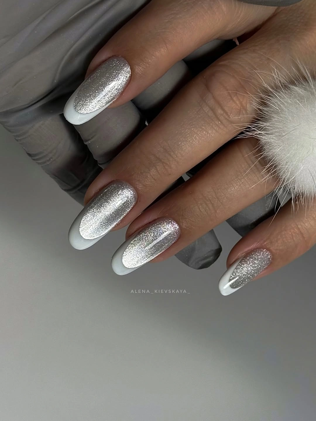 Almond nails with silver shimmer bases and clean white tips