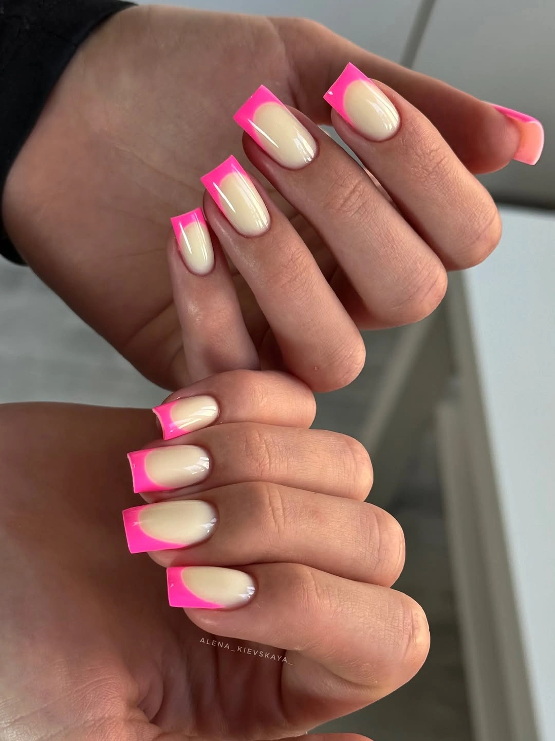 Short square creamy nude nails with neon pink French tips