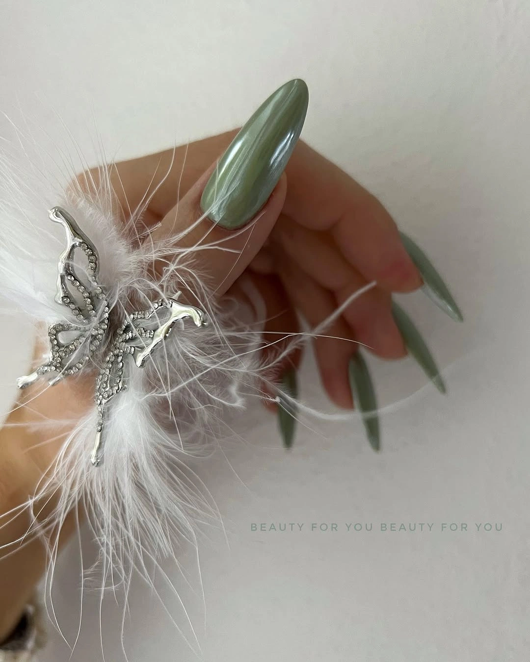 Long muted olive almond nails with a glossy clean finish