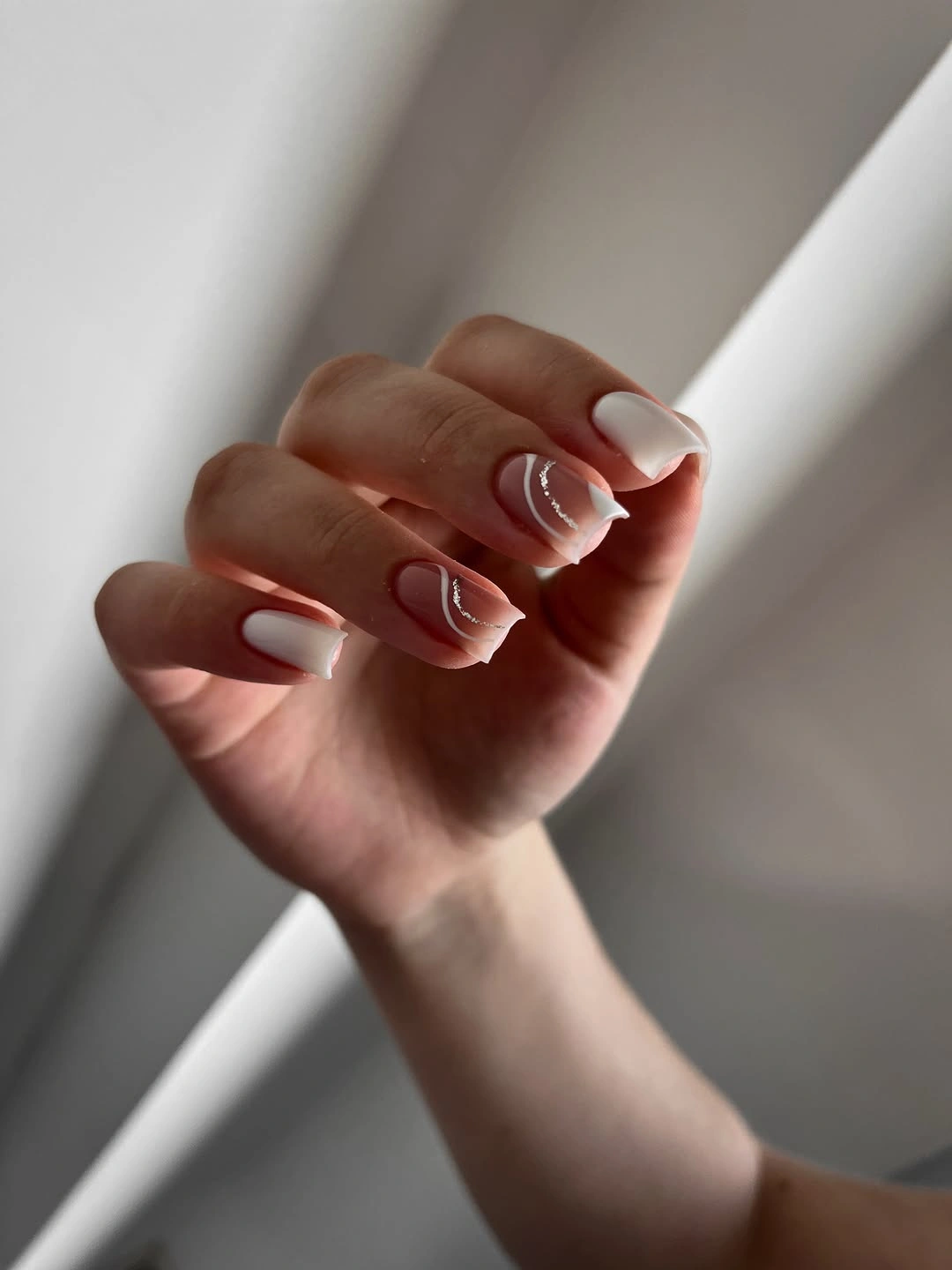 White nails with curved silver accent line art